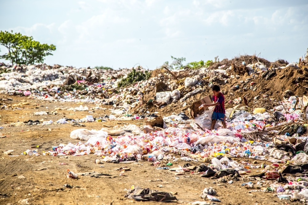 plastic pollution solutions Boy at landfill sites