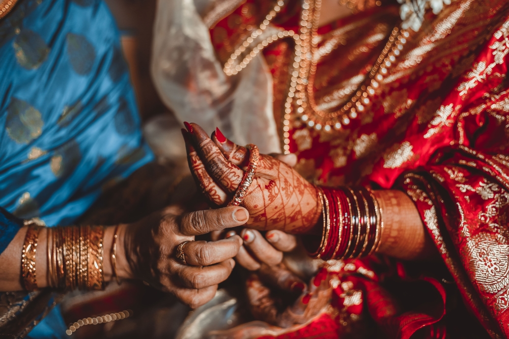 dowry system, Woman putting bangles on bride